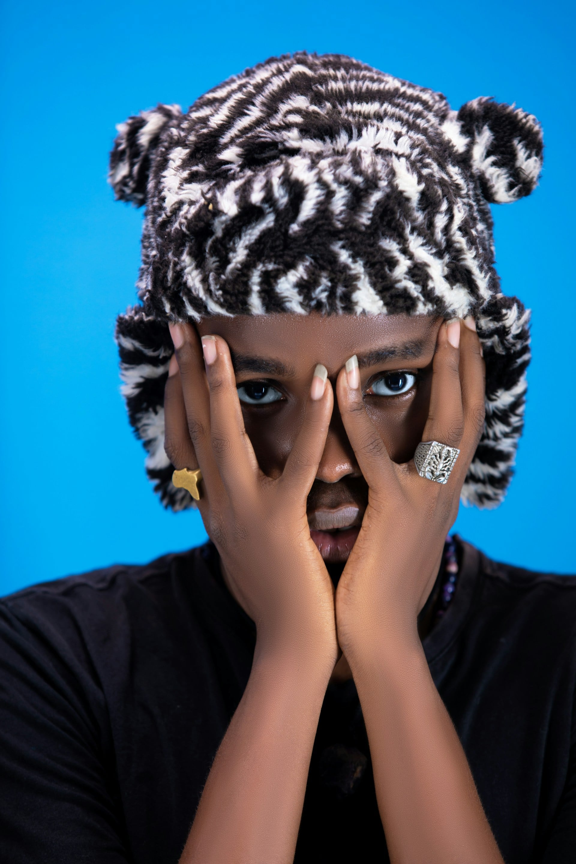 Smiling woman with wireless headphones watching entertainment show laptop while sitting desk african american freelancer looking funny social media content portable computer
